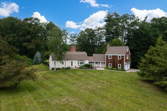 46 Baldpate Rd, Boxford, MA 01921 - rear view of house featuring a garage, a yard, and a chimney