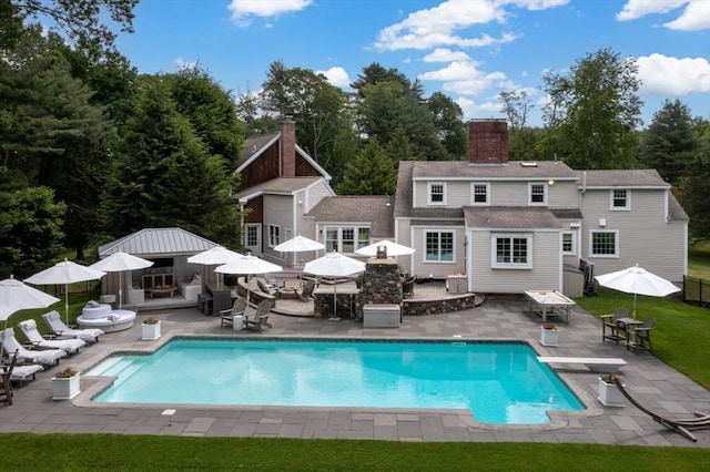 46 Baldpate Rd, Boxford, MA 01921 - outdoor pool featuring outdoor dining space, a patio, a diving board, and view of wooded area
