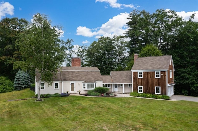 46 Baldpate Rd, Boxford, MA 01921 - view of front of property featuring a chimney, concrete driveway, a front yard, and a garage