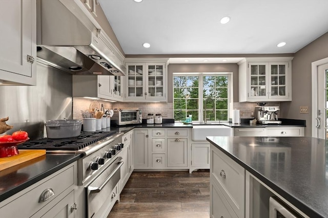 46 Baldpate Rd, Boxford, MA 01921 - kitchen with exhaust hood, recessed lighting, dark countertops, backsplash, and dark wood-type flooring