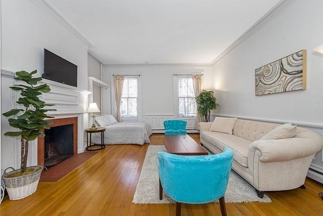 227 Marlborough St Unit 4, Boston, MA 02116 - living area featuring ornamental molding, a fireplace with flush hearth, wood finished floors, a decorative wall, and a wainscoted wall