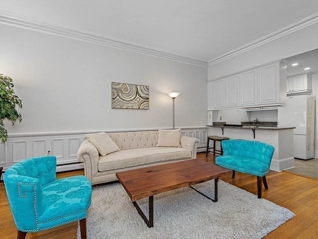 227 Marlborough St Unit 4, Boston, MA 02116 - living area featuring ornamental molding, light wood finished floors, a baseboard radiator, and recessed lighting
