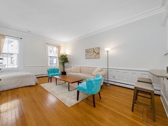 227 Marlborough St Unit 4, Boston, MA 02116 - living room featuring ornamental molding, baseboard heating, healthy amount of natural light, hardwood / wood-style flooring, and a decorative wall