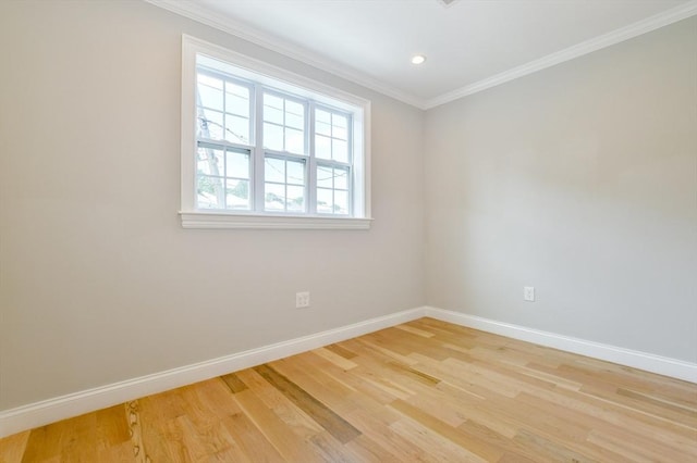 empty room featuring ornamental molding, baseboards, light wood finished floors, and recessed lighting