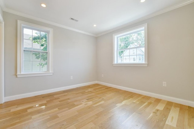 empty room with plenty of natural light, baseboards, light wood finished floors, recessed lighting, and ornamental molding