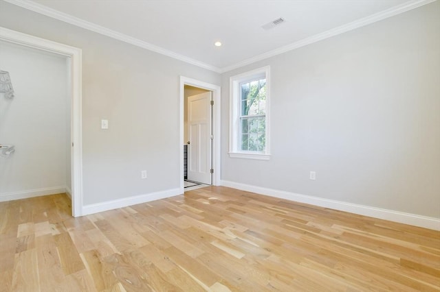 unfurnished room featuring light wood-type flooring, baseboards, crown molding, and recessed lighting