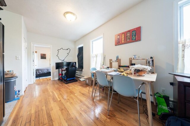 309 Elm St Unit 3, Cambridge, MA 02139 - home office featuring light wood-style floors, healthy amount of natural light, and baseboard heating