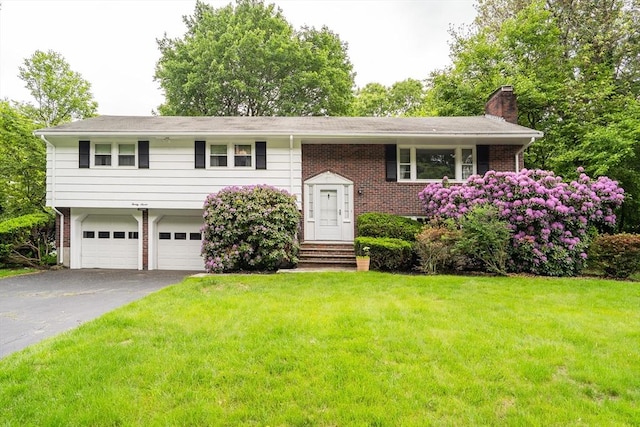 27 Philip Rd, Lexington, MA 02421 - split foyer home with a chimney, asphalt driveway, a front lawn, a garage, and brick siding