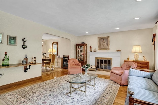 27 Philip Rd, Lexington, MA 02421 - living room featuring arched walkways, light wood-type flooring, a brick fireplace, and recessed lighting