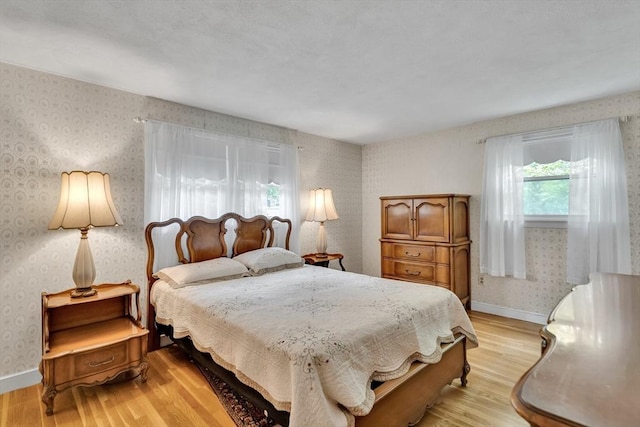 27 Philip Rd, Lexington, MA 02421 - bedroom featuring wallpapered walls, light wood-style flooring, and baseboards