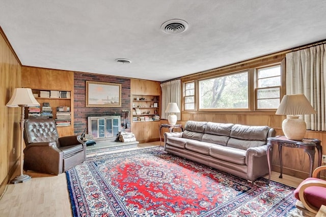 27 Philip Rd, Lexington, MA 02421 - living area with wood walls, a brick fireplace, and wood finished floors