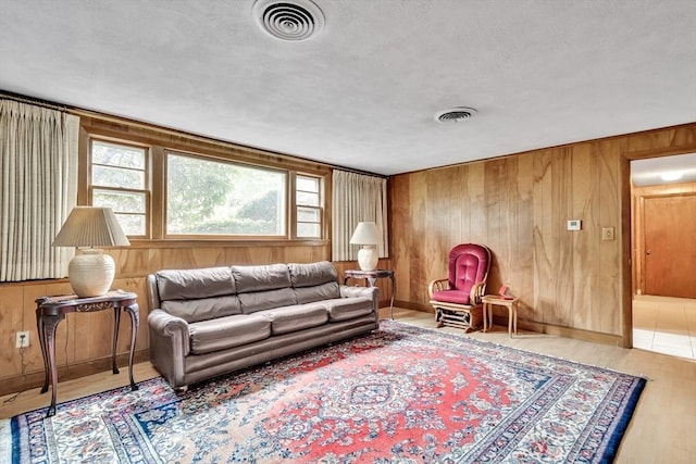 27 Philip Rd, Lexington, MA 02421 - living area with wood walls, wood finished floors, baseboards, and a textured ceiling