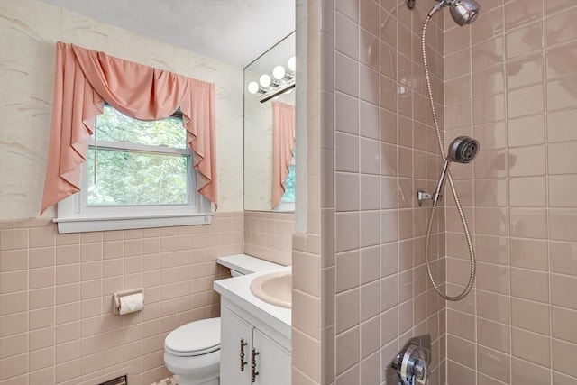 27 Philip Rd, Lexington, MA 02421 - bathroom featuring tiled shower, vanity, toilet, and tile walls