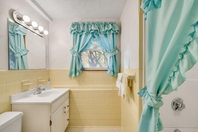 27 Philip Rd, Lexington, MA 02421 - full bath with vanity, toilet, tile walls, and a textured ceiling
