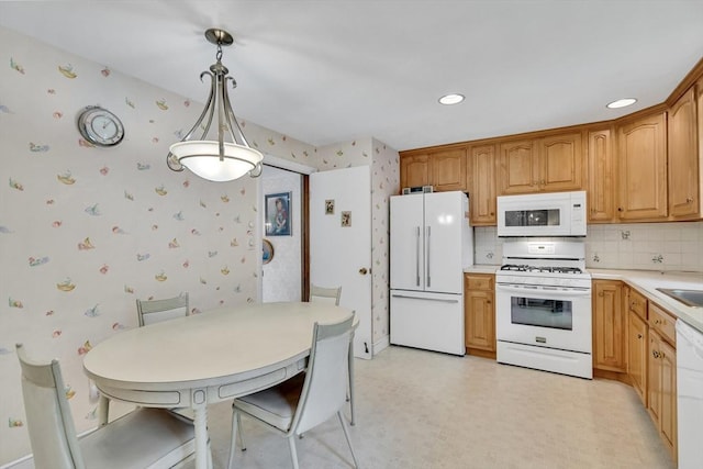 27 Philip Rd, Lexington, MA 02421 - kitchen with white appliances, wallpapered walls, backsplash, light countertops, and hanging light fixtures