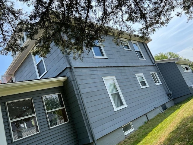 view of side of home with a lawn