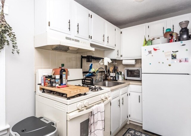 57 Prospect St, Watertown, MA 02472 - kitchen with white appliances, under cabinet range hood, a sink, decorative backsplash, and white cabinetry