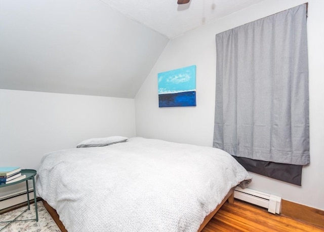 57 Prospect St, Watertown, MA 02472 - bedroom with baseboard heating, vaulted ceiling, ceiling fan, and wood finished floors
