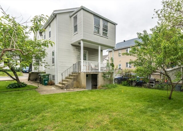 57 Prospect St, Watertown, MA 02472 - rear view of property with a lawn and stairway