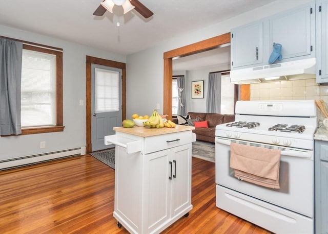 57 Prospect St, Watertown, MA 02472 - kitchen featuring gas range gas stove, under cabinet range hood, a ceiling fan, light countertops, and light wood-type flooring