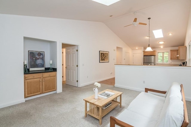 48 Northern Ave Unit 48, Northampton, MA 01060 - living room featuring a skylight, a ceiling fan, baseboards, light carpet, and high vaulted ceiling