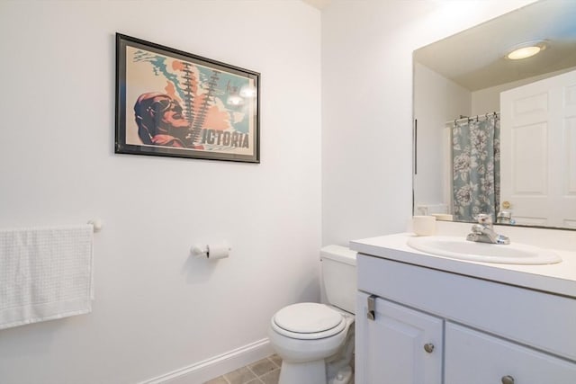 48 Northern Ave Unit 48, Northampton, MA 01060 - bathroom featuring vanity, toilet, baseboards, and tile patterned floors