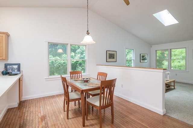 48 Northern Ave Unit 48, Northampton, MA 01060 - dining space with high vaulted ceiling, light wood-style flooring, a skylight, and baseboards