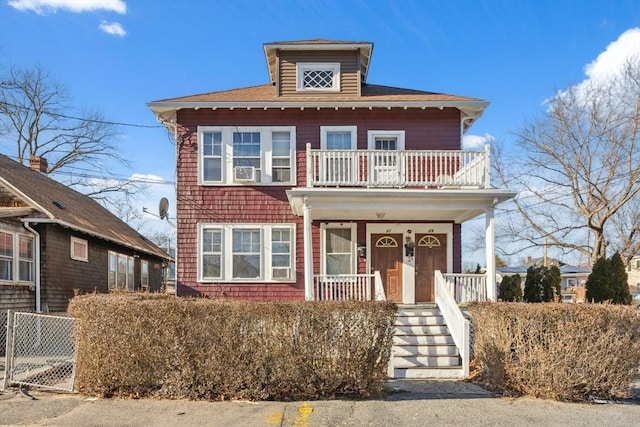 view of front facade with covered porch and a balcony