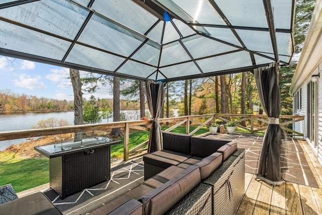 sunroom / solarium with a water view, an outdoor living space, and vaulted ceiling
