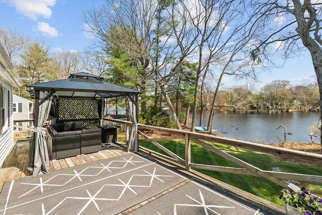 wooden terrace with an outdoor hangout area, a gazebo, and a water view