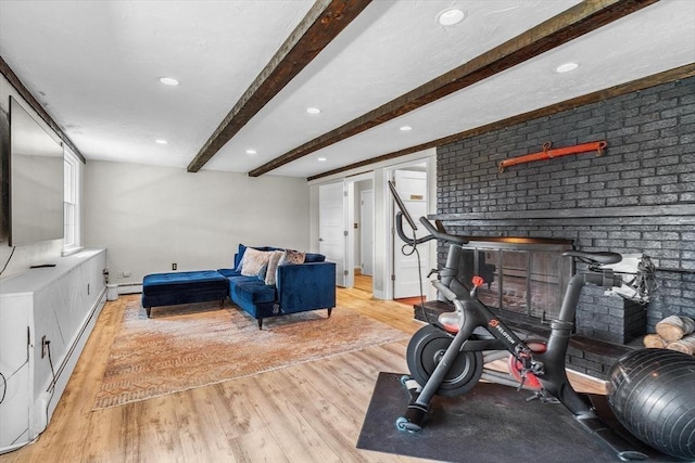 workout room with light wood-style floors, recessed lighting, and baseboard heating