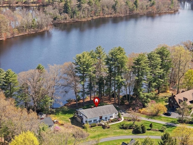 view of subject property featuring a nearby body of water and a forest