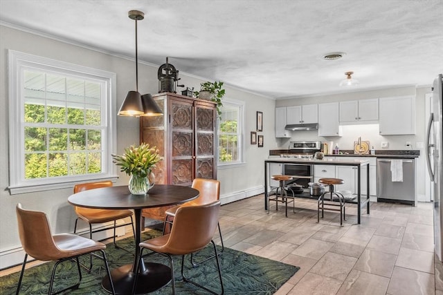 dining room with crown molding and baseboards