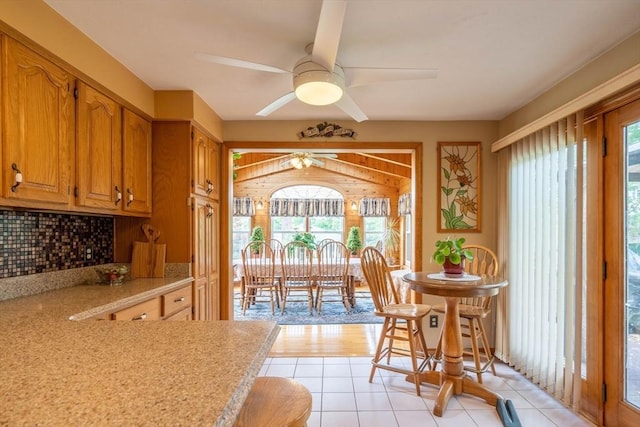 dining area with a ceiling fan and light tile patterned floors