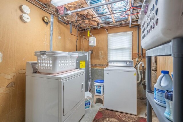 washroom featuring washing machine and dryer and water heater