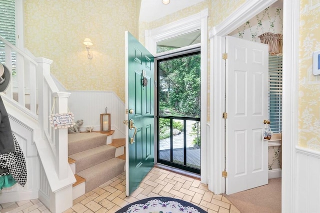 8 Barn Ln, Gloucester, MA 01930 - entryway with wallpapered walls, stairway, and a wainscoted wall