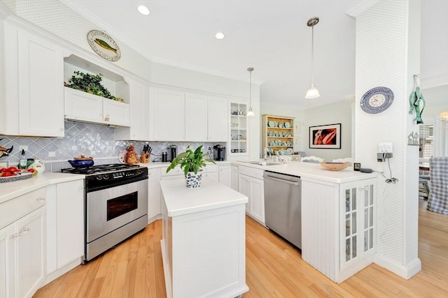 8 Barn Ln, Gloucester, MA 01930 - kitchen featuring stainless steel appliances, glass insert cabinets, white cabinetry, recessed lighting, and ornamental molding