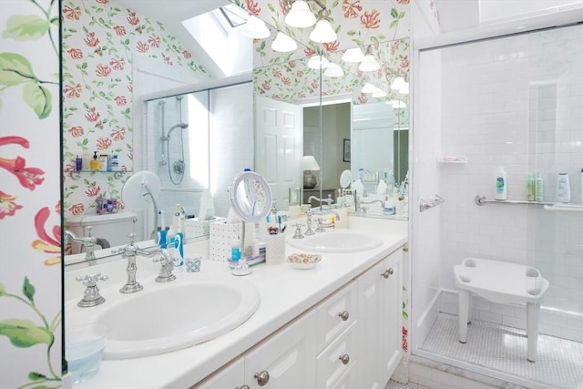 8 Barn Ln, Gloucester, MA 01930 - full bathroom featuring a skylight, wallpapered walls, a stall shower, and double vanity