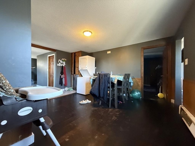 living room featuring a textured ceiling and wainscoting