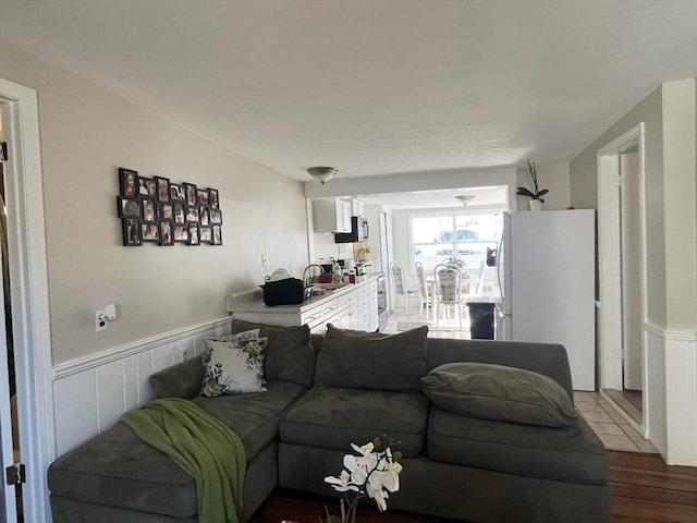 living room with wainscoting and wood finished floors