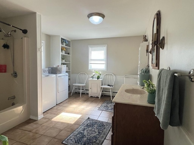 bathroom featuring a baseboard heating unit, bathing tub / shower combination, vanity, independent washer and dryer, and tile patterned floors