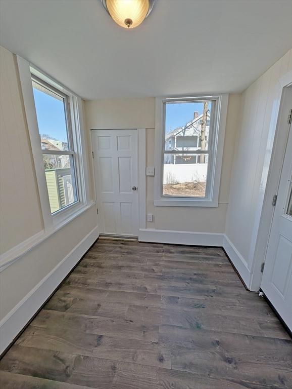 interior space featuring baseboards and wood finished floors