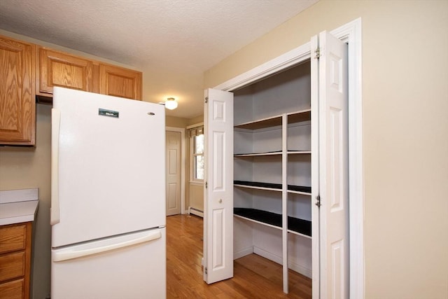 storage area featuring a baseboard heating unit