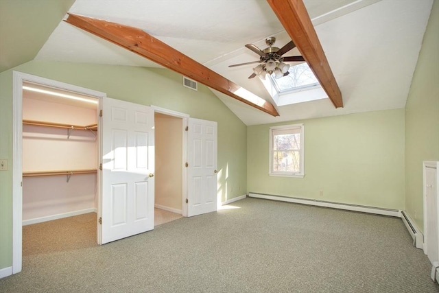 additional living space featuring lofted ceiling with skylight, baseboard heating, visible vents, and baseboards