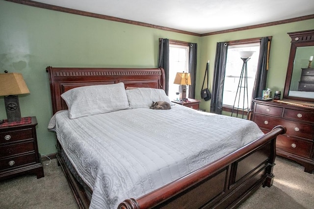 carpeted bedroom with ornamental molding