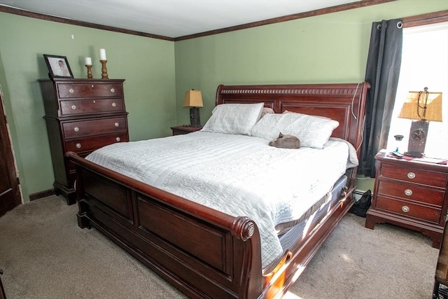 bedroom with light colored carpet, crown molding, and baseboards