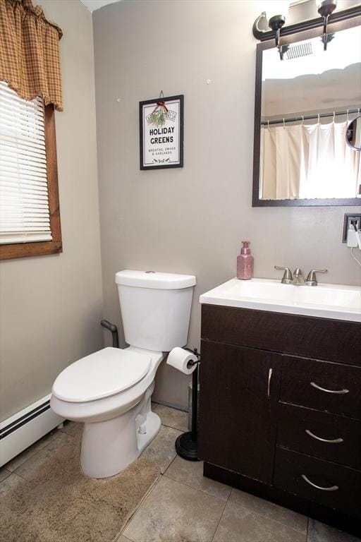 full bathroom with tile patterned flooring, baseboard heating, vanity, and toilet