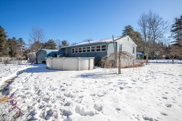 snow covered house with an outdoor pool