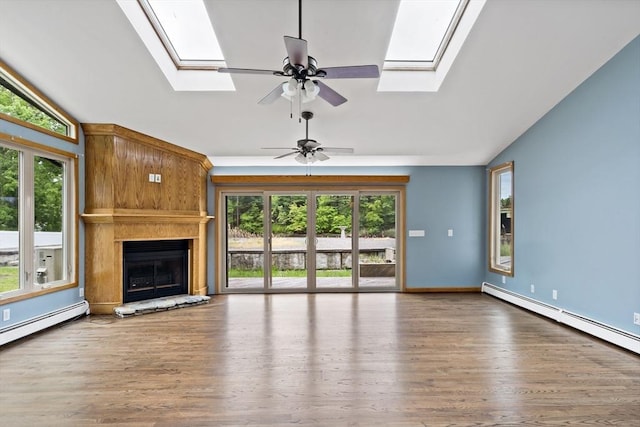 43 Water St, Freetown, MA 02702 - unfurnished living room with a skylight, lofted ceiling, baseboard heating, ceiling fan, and a large fireplace