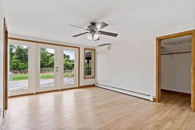 43 Water St, Freetown, MA 02702 - unfurnished bedroom with baseboard heating, access to exterior, light wood-type flooring, an AC wall unit, and a spacious closet